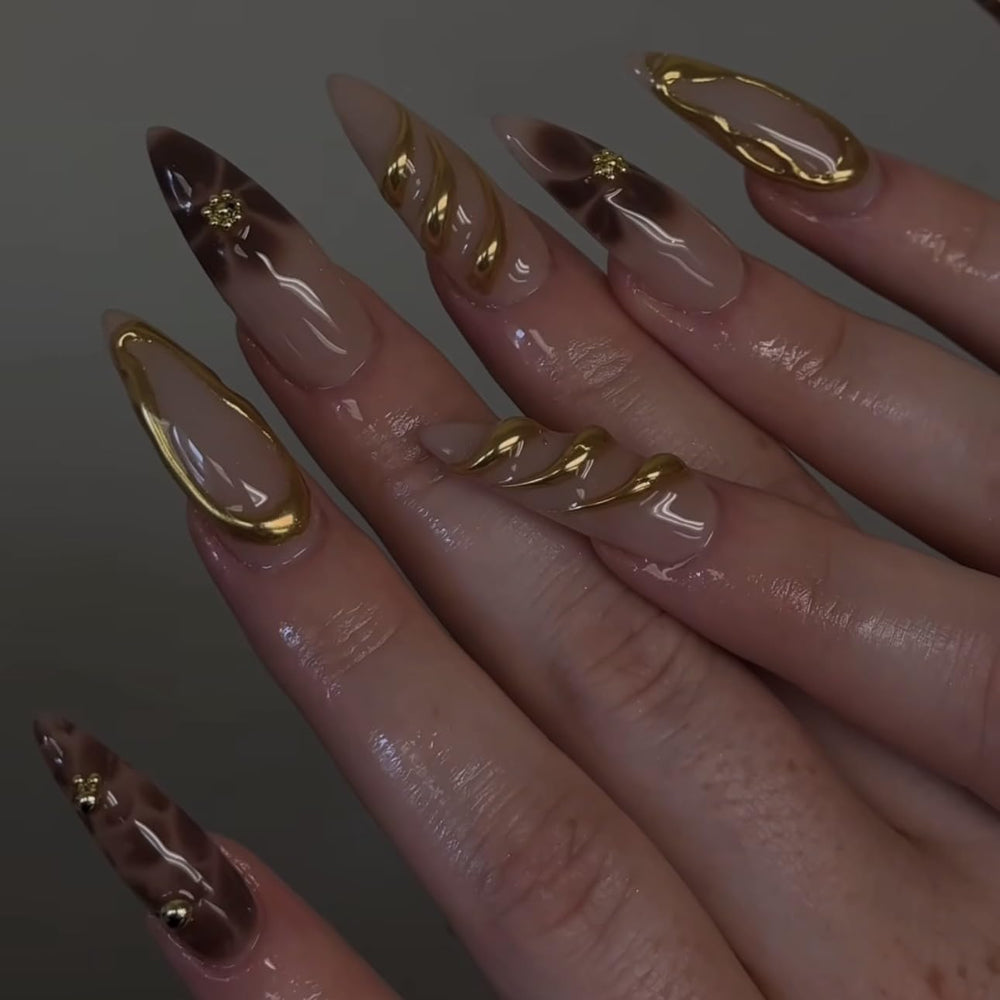LPOODDNU detailed shot of 3D gold flower embellishment for elevated manicure style