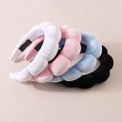 Luckybear headband next to hand showing size and stretch fit