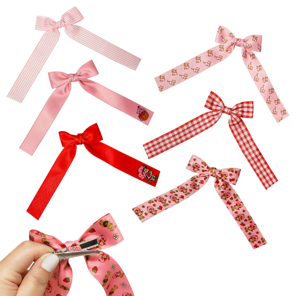 Seven LUV HER bows laid flat to show variety and mix-and-match outfit options