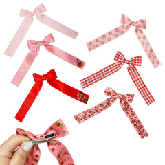Seven LUV HER bows laid flat to show variety and mix-and-match outfit options