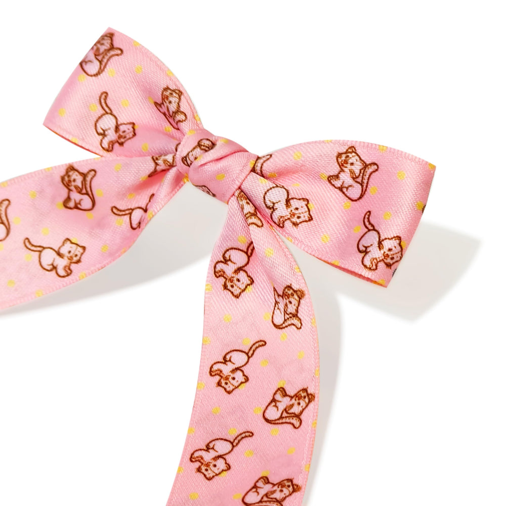 Hand holding LUV HER bow for size comparison to help choose appropriate child fit