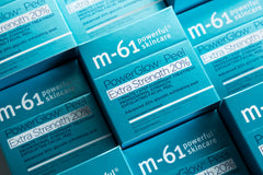 m-61 pad beside a coin to show true size and portability for travel-friendly benefit