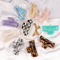 Magicsky clip held in hand to show 3.2 by 1.6 inch size scale