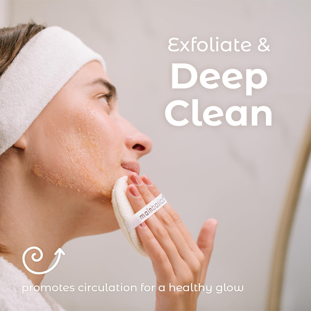 MainBasics face scrubber held in hand demonstrating size and easy handling benefit