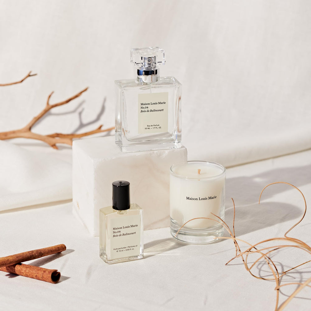 Maison Louis Marie bottle with wood and spice props showing woody scent inspiration benefit