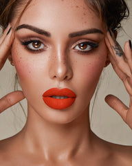 MAKI YIKA lipstick on model lips illustrating true matte orange and long-lasting look