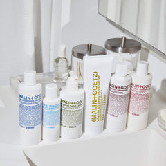 MALIN+GOETZ bottle staged in bathroom setting suggesting daily routine