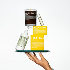 MALIN+GOETZ ingredients display with avocado and grapeseed emphasizing nourishing oils