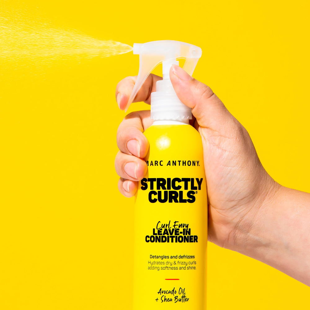 Marc Anthony 8.4 fl oz bottle beside a hand to show true size