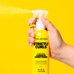 Marc Anthony 8.4 fl oz bottle beside a hand to show true size