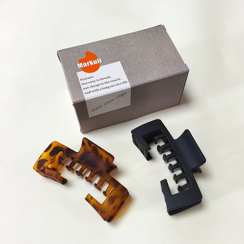 Markuii clip beside a hand showing 4.1-inch size for scale