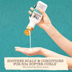 Maui Moisture bottle in hand showing 13 fl oz size for easy scale