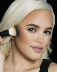 MAYBELLINE bronzer inside makeup bag in a casual setting for on-the-go touch-ups