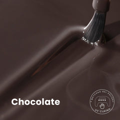 MAYCHAO brush swiping chocolate gel polish showcasing smooth even coverage