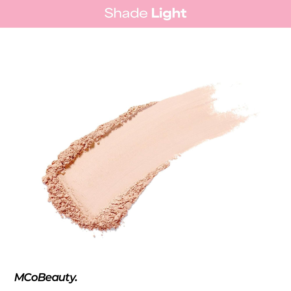 Pressing MCoBeauty Light with a puff under the eye to bake and lock concealer for long wear