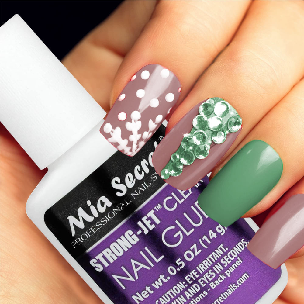 Mia Secret bottle pictured with tweezers and crystals for professional use