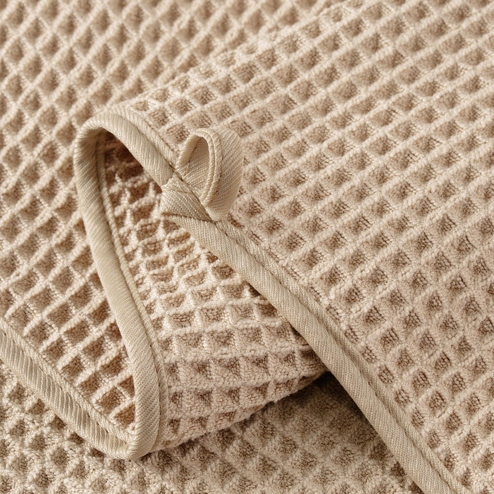 MICROFI towel held in hand showing 13x13 inch scale and easy handling