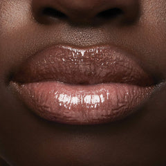 Milani lifestyle bag shot showing gloss ready for on-the-go touch-ups