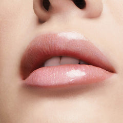 Milani lifestyle model smiling wearing gloss for luminous, fuller-looking lips