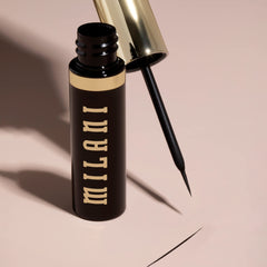 Milani eyeliner next to coin for size comparison showing compact portability benefit
