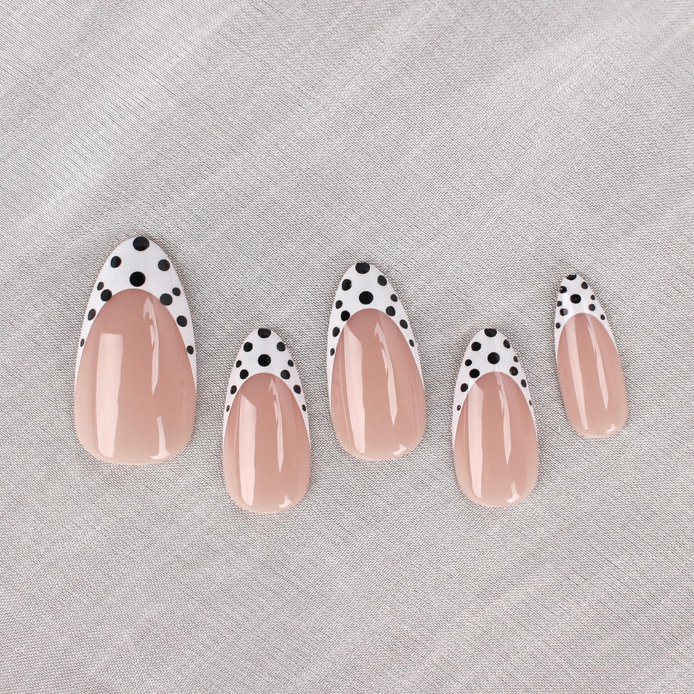 Mivota close-up of black and white polka dot French tips for a chic accent