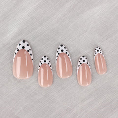 Mivota close-up of black and white polka dot French tips for a chic accent