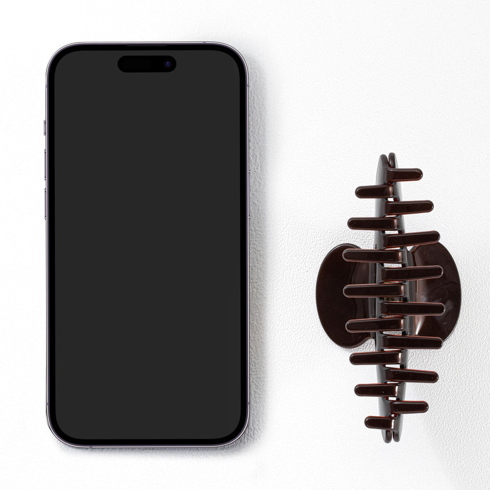 Mixcbe clip styled in a bun on model demonstrating reliable hold and polished look