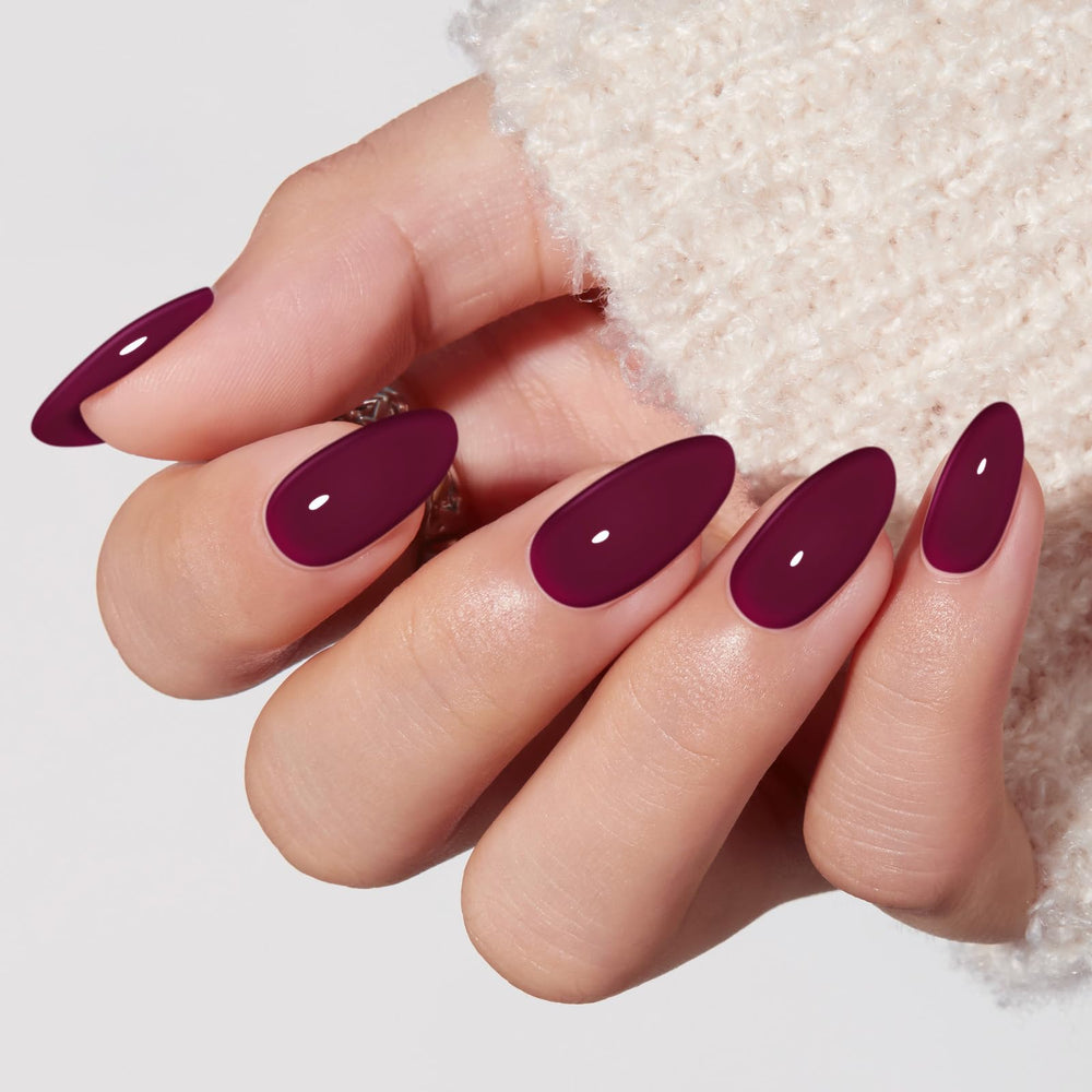 Modelones close-up of glossy burgundy almond nail finish highlighting salon-quality shine