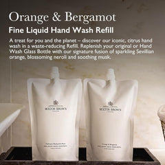 Molton Brown refill being poured into glass bottle demonstrating waste reduction