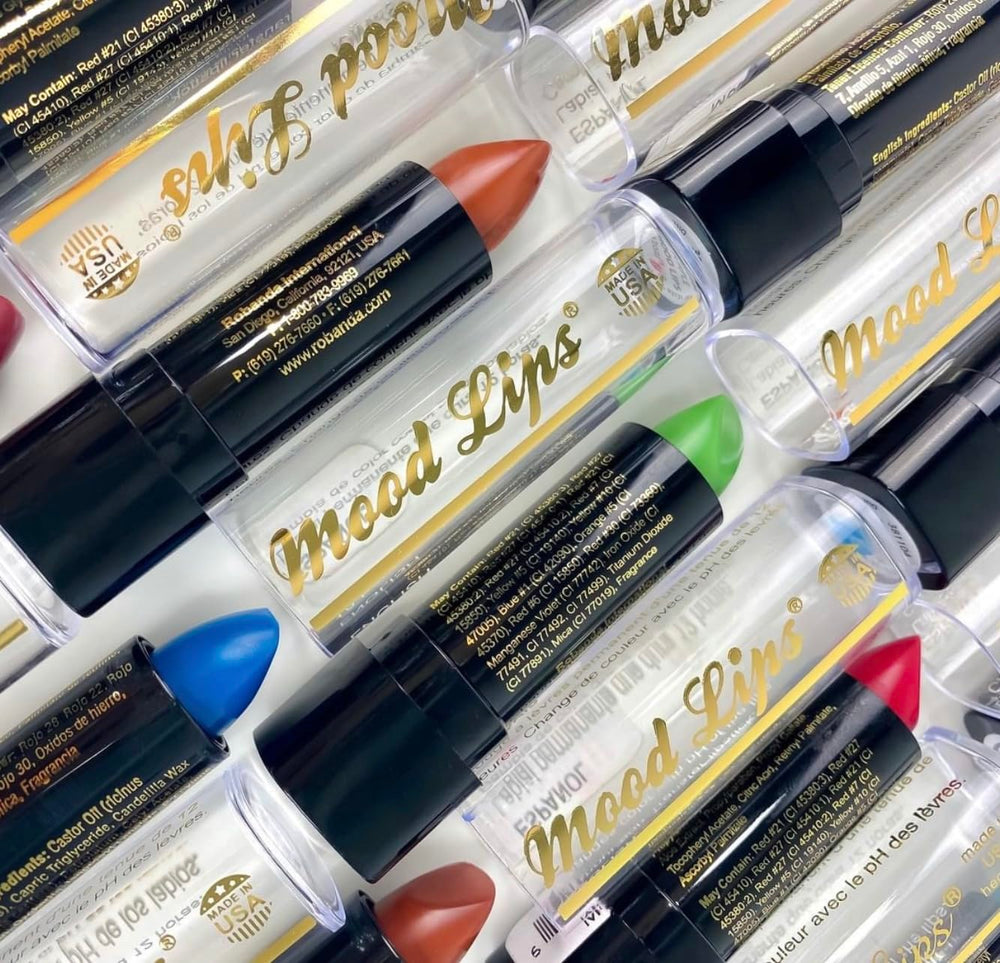 Mood Lips next to common objects for scale, showing compact travel-friendly size