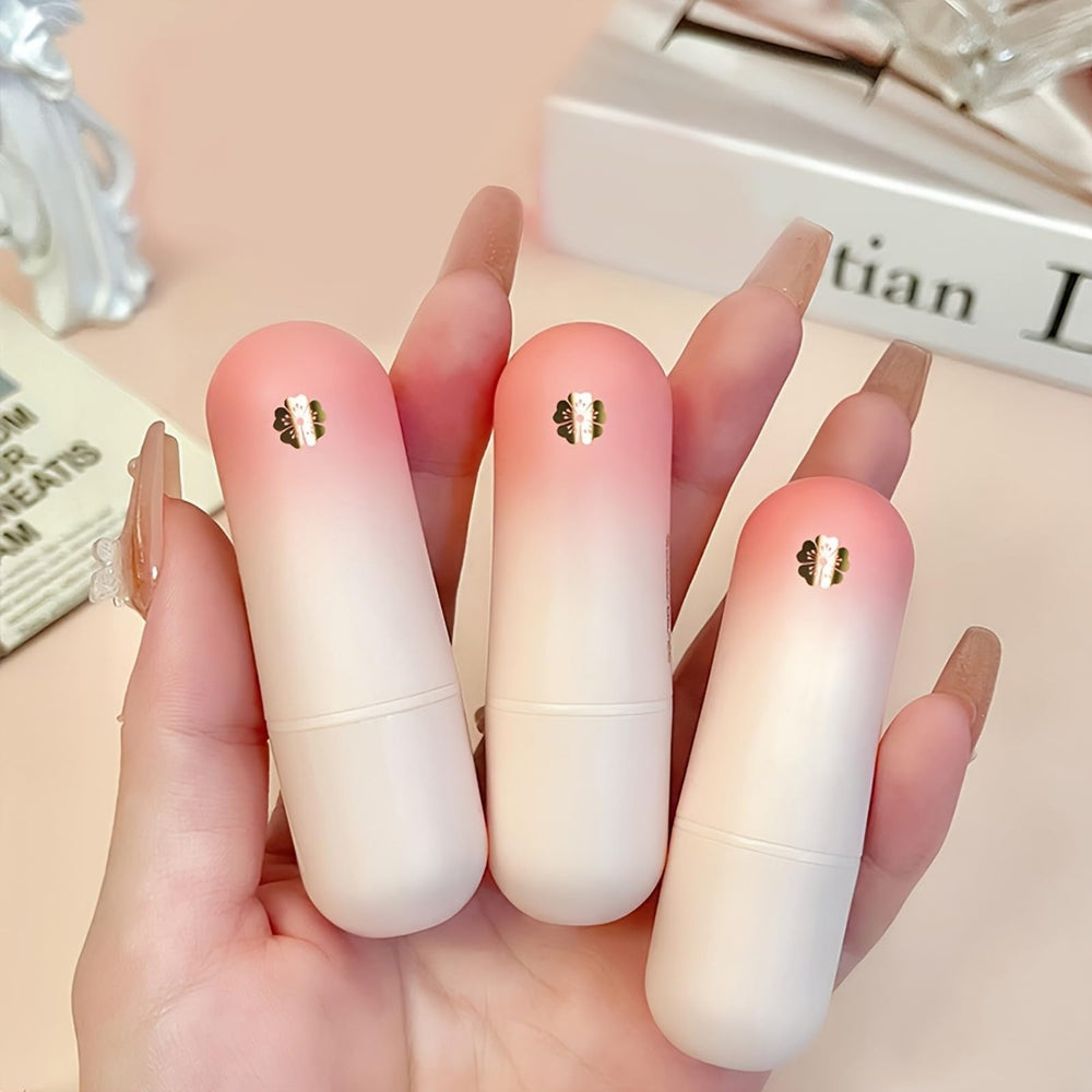 MooGlamor tubes beside a hand to show slim size and travel-friendly convenience