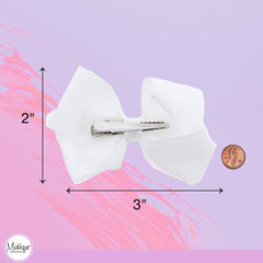 Motique Accessories bow next to ruler showing 3-inch size for fit clarity