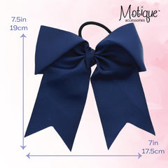Motique Accessories bow beside ruler for size comparison and visible 7 inch width