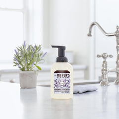 Mrs. MEYER'S bottle held in hand showing 10 oz scale and convenient size benefit
