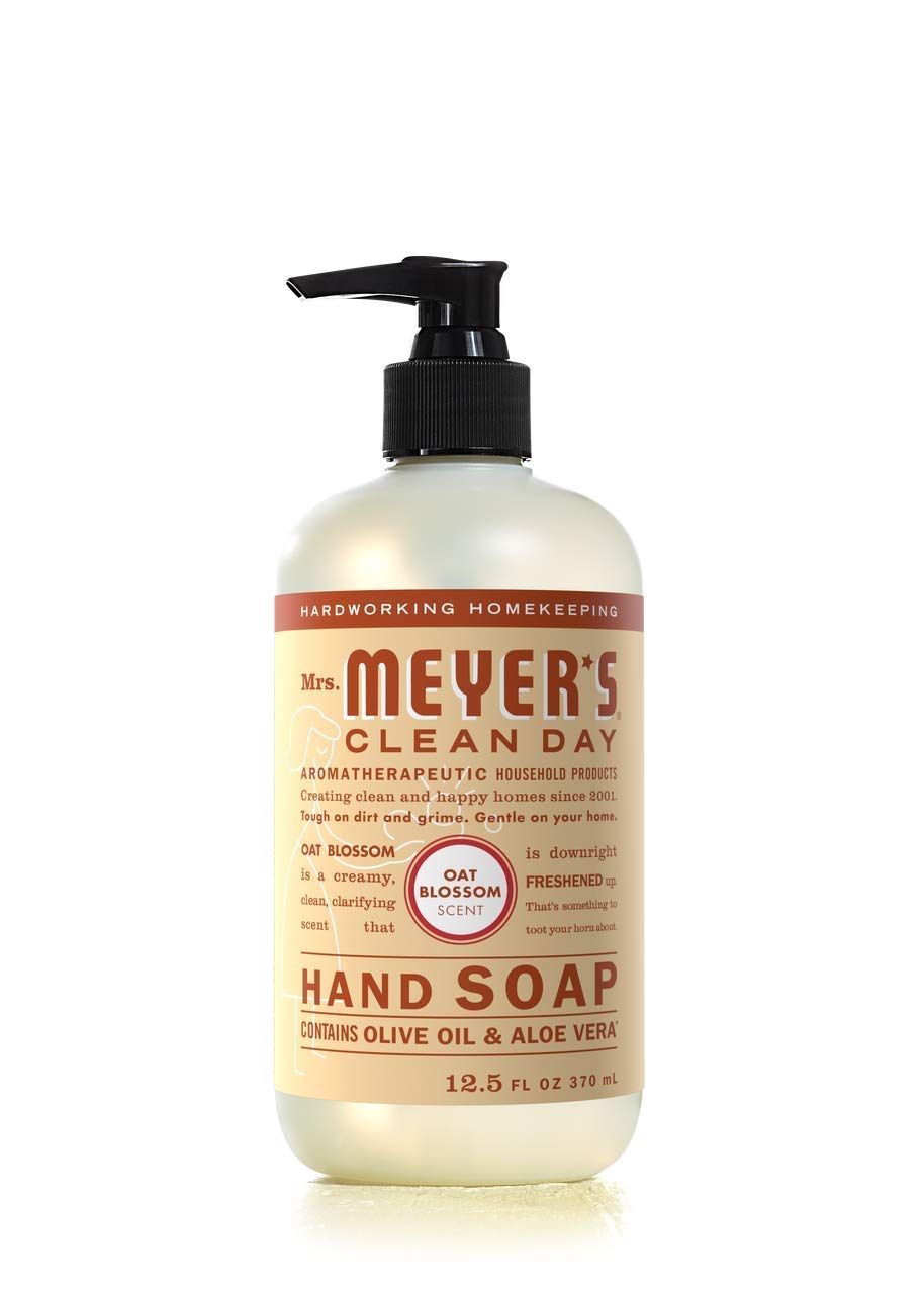 Mrs. MEYER'S size comparison with hand to show compact 12.5 oz bottle portability and space saving