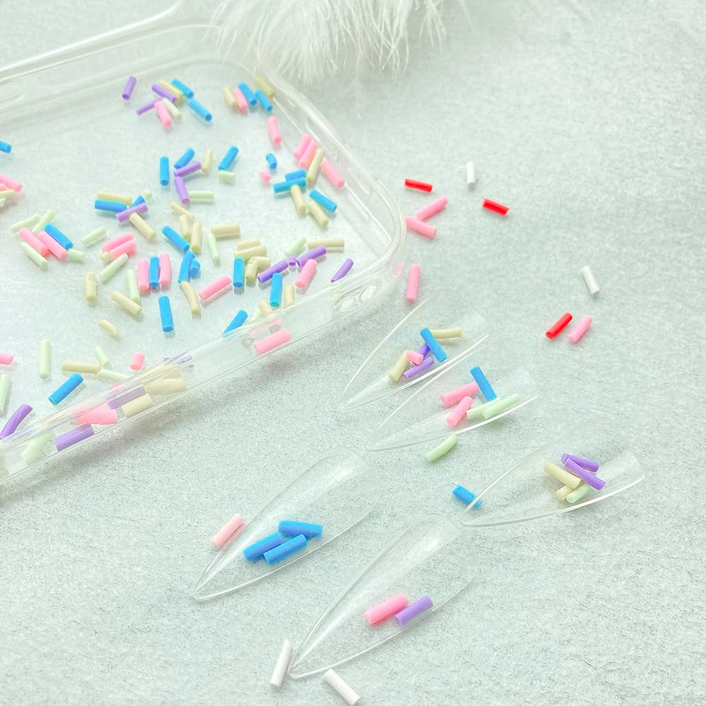 Mulutoo sprinkles next to a teaspoon, demonstrates compact quantity size