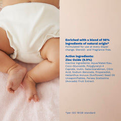 Mustela tube in adult hand showing 3.8 oz scale for clear sizing