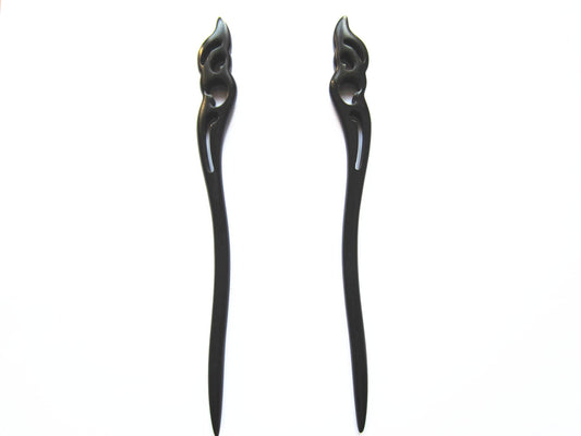 Myhsmooth front view of two ebony sticks showing elegant hold the moon carving and secure styling benefit