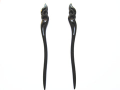 Myhsmooth front view of two ebony sticks showing elegant hold the moon carving and secure styling benefit
