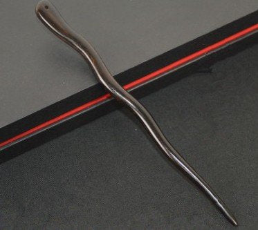 Myhsmooth in use securing a bun for stable, polished updos