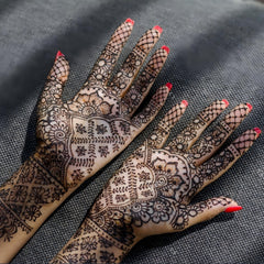 Mzstgh stencil applied on hand while henna is being filled for neat result