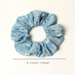 naibirdr scrunchie holding a ponytail in profile demonstrates secure grip benefit