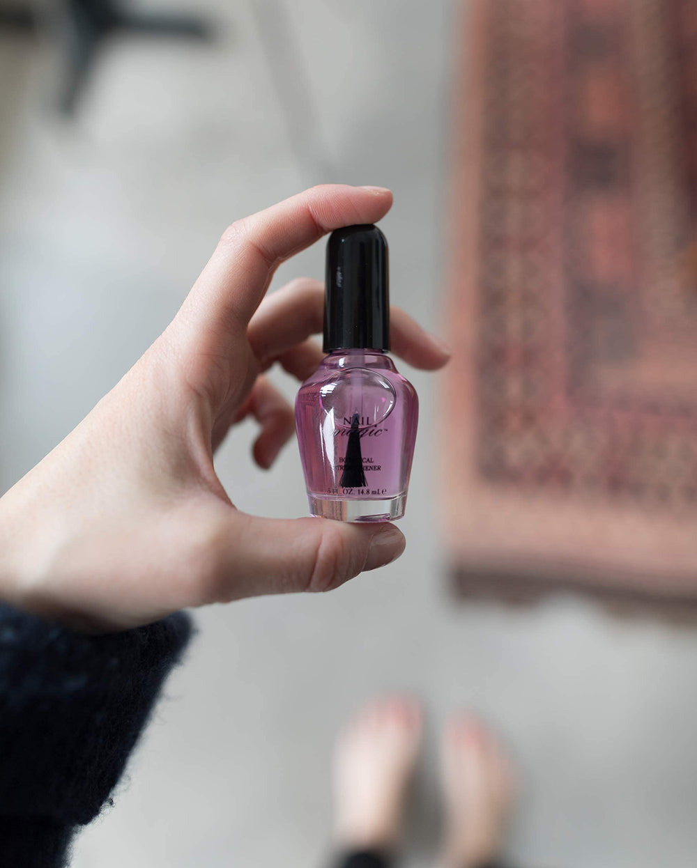 Nail Magic bottle next to a ruler showing 0.5 fl oz scale