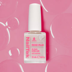 Nail Tek bottle next to manicure tools in a salon scene for professional finish benefit