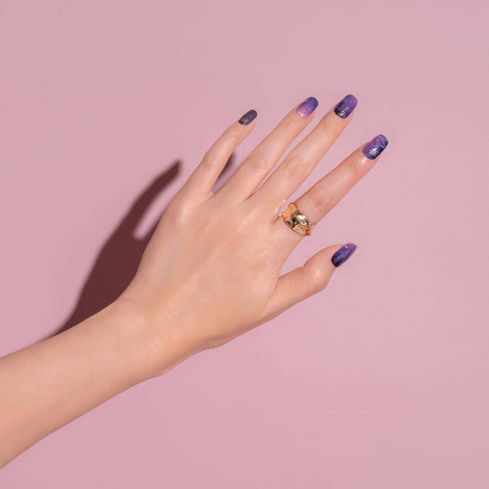 NAILOG hand applying a strip demonstrating quick salon-style result at home