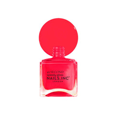 Nails Inc CHARLIE bottle in hand for scale showing compact travel-friendly benefit