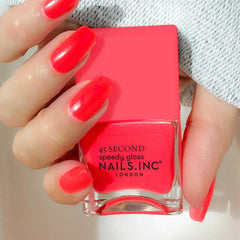 Nails Inc CHARLIE swatch on skin showing true neon coral coverage benefit