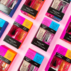 Nails Inc mini bottles held in hand to show compact size and portability