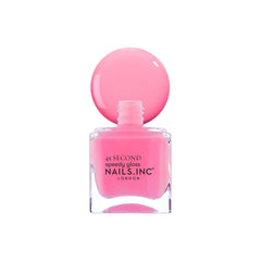 Nails Inc Taylor next to a coin for scale to show 0.47 fl oz bottle size benefit