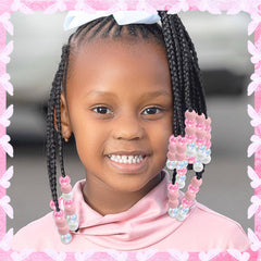 NAISKA beads threaded on a toddler braid adding playful color and secure hold
